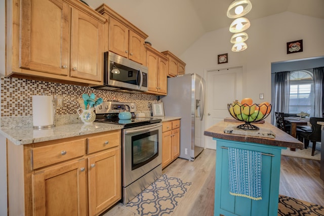 kitchen featuring lofted ceiling, backsplash, appliances with stainless steel finishes, and light wood finished floors