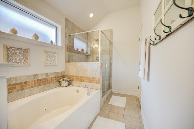 bathroom with a tub with jets, baseboards, lofted ceiling, a stall shower, and tile patterned flooring