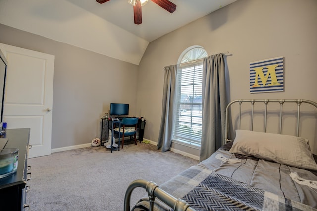 carpeted bedroom with a ceiling fan, baseboards, and vaulted ceiling