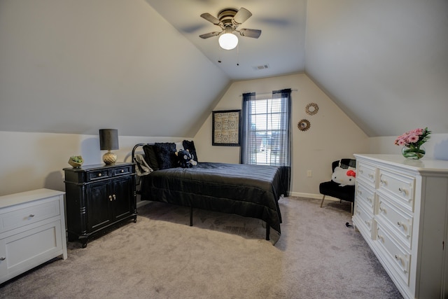 bedroom with a ceiling fan, vaulted ceiling, light colored carpet, and visible vents