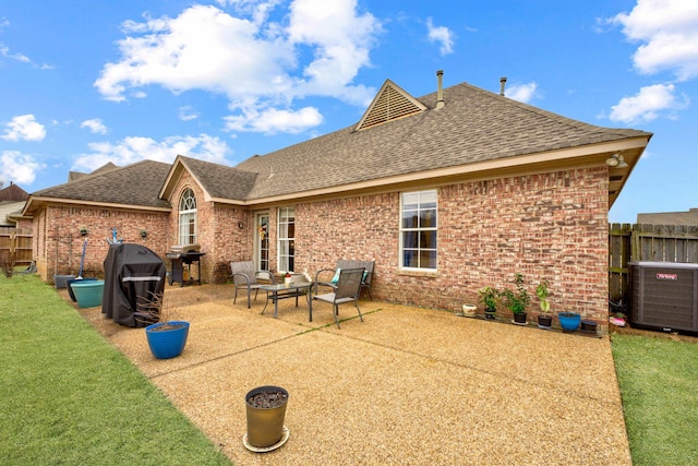 back of property featuring a patio, fence, a shingled roof, a lawn, and brick siding