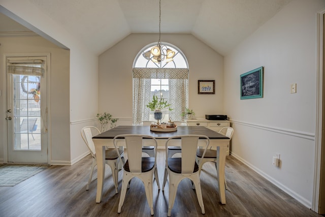 dining space with vaulted ceiling, plenty of natural light, and wood finished floors