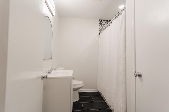 bathroom with tile patterned floors, toilet, vanity, and baseboards