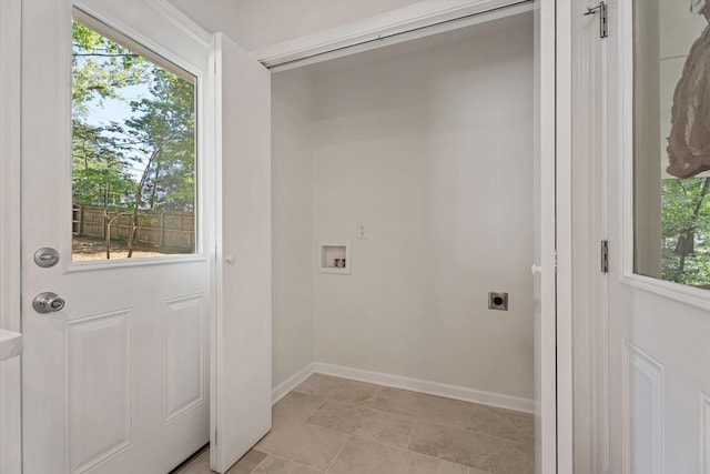 clothes washing area featuring washer hookup, laundry area, baseboards, and hookup for an electric dryer