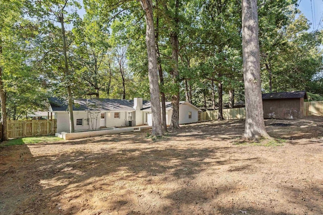 exterior space featuring an outbuilding, a fenced backyard, and a shed