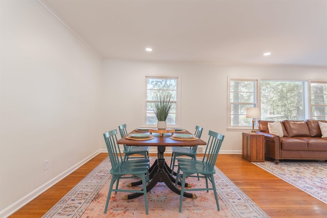 dining room with light wood-style flooring, recessed lighting, and baseboards