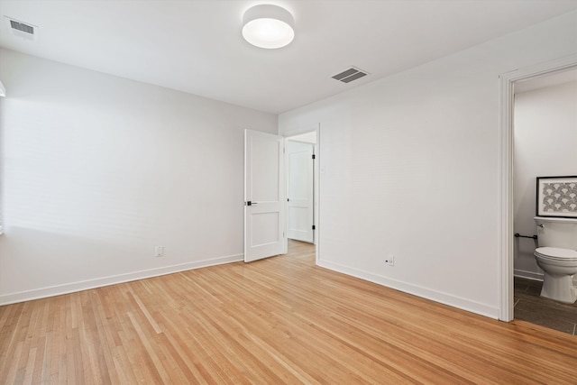 unfurnished bedroom featuring light wood-type flooring, visible vents, and baseboards