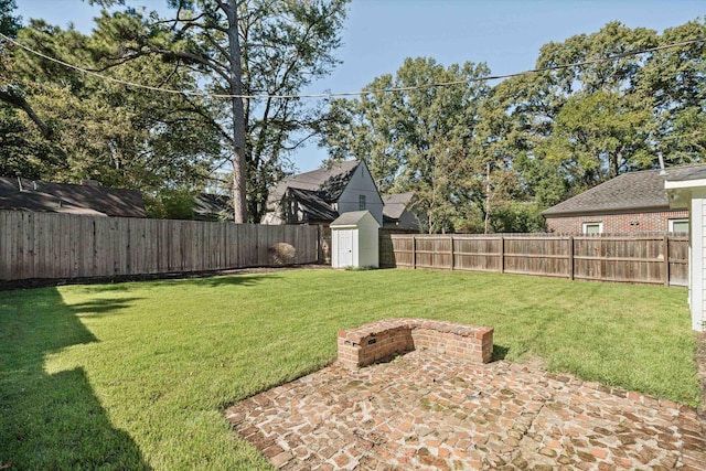 view of yard with a fenced backyard, a storage shed, an outdoor structure, and a patio area