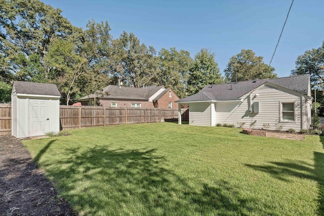 view of yard featuring a storage unit, an outdoor structure, and a fenced backyard