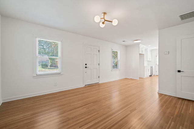 entrance foyer with baseboards, visible vents, a wealth of natural light, and light wood-type flooring