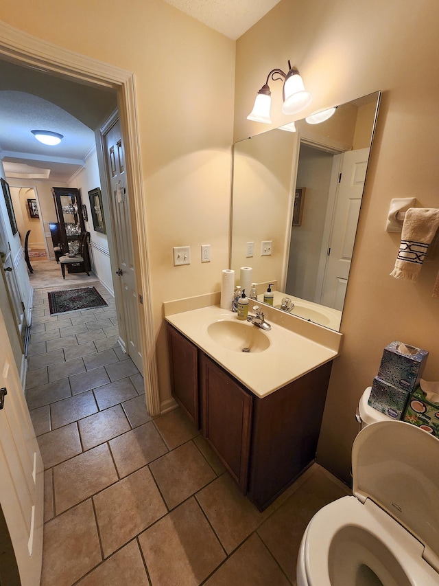 bathroom featuring vanity, tile patterned floors, and toilet