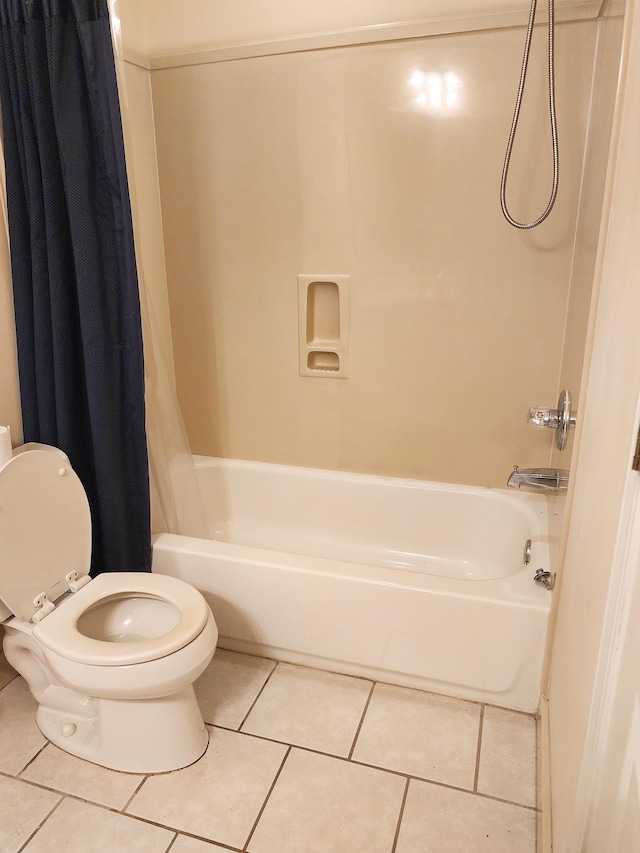 full bathroom featuring tile patterned floors, toilet, and shower / bath combo