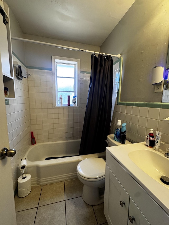 full bath with vanity, tile patterned flooring, tile walls, toilet, and shower / tub combo with curtain