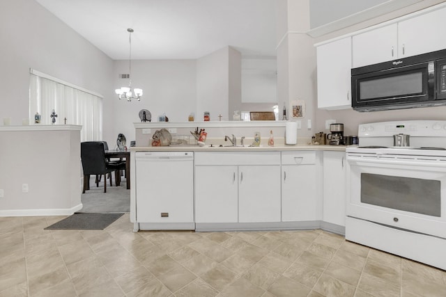 kitchen featuring white appliances, a chandelier, white cabinets, and light countertops