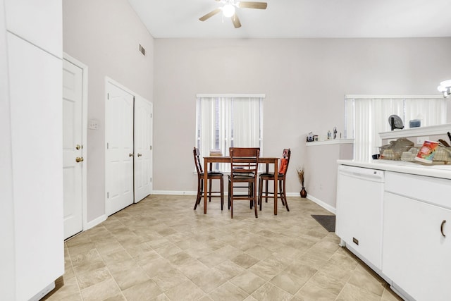 dining space featuring ceiling fan and baseboards