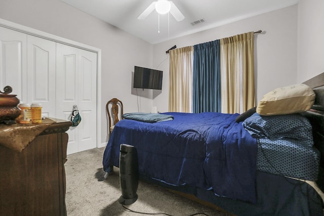 bedroom featuring visible vents, a ceiling fan, a closet, and carpet flooring