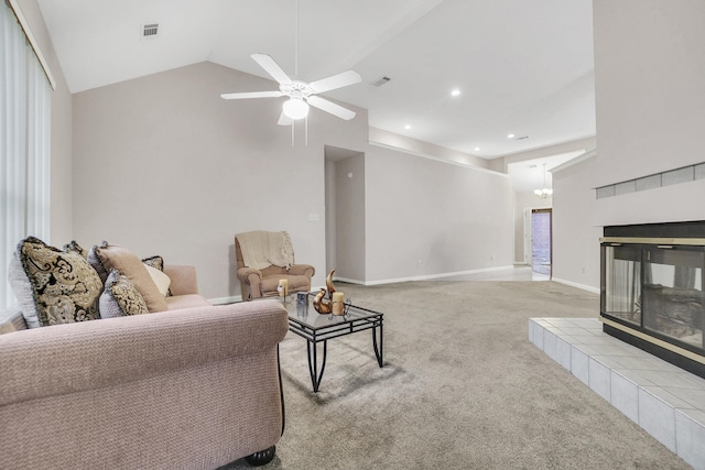 carpeted living room featuring visible vents, baseboards, high vaulted ceiling, and a tile fireplace