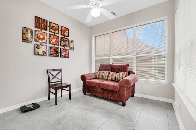 sitting room featuring baseboards and a ceiling fan