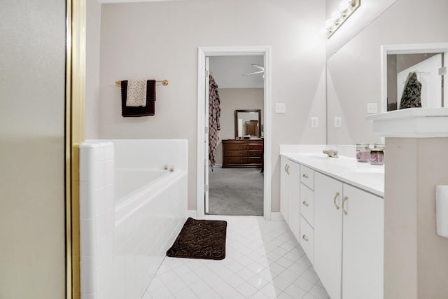 bathroom featuring tile patterned floors, a sink, a garden tub, and double vanity