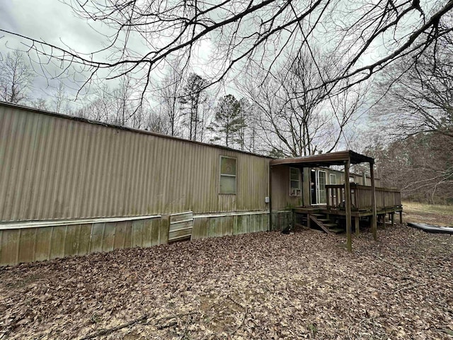 view of side of home with a wooden deck