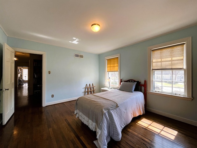 bedroom featuring dark wood-style floors, visible vents, and baseboards