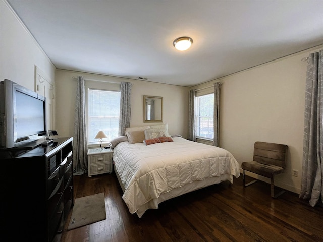 bedroom with visible vents and dark wood-type flooring