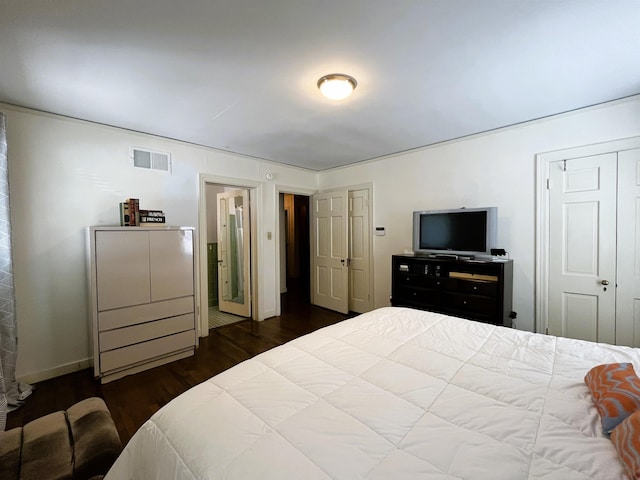 bedroom featuring visible vents, baseboards, and dark wood-style flooring