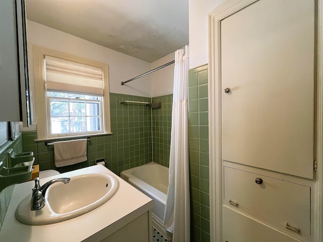 bathroom with vanity, tile walls, and shower / tub combo