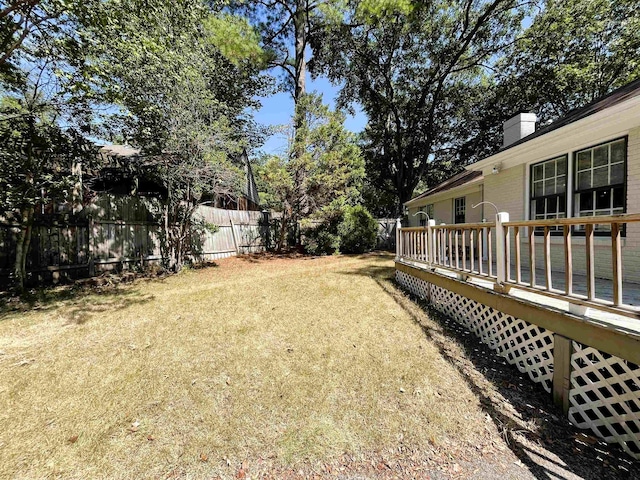 view of yard with a deck and fence