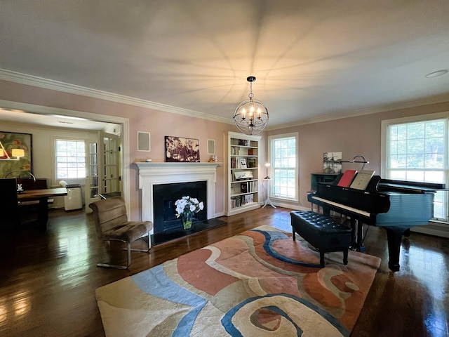 interior space featuring dark wood finished floors, an inviting chandelier, a fireplace, and ornamental molding