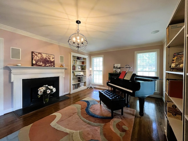 sitting room featuring dark wood finished floors, a notable chandelier, a fireplace with raised hearth, and crown molding