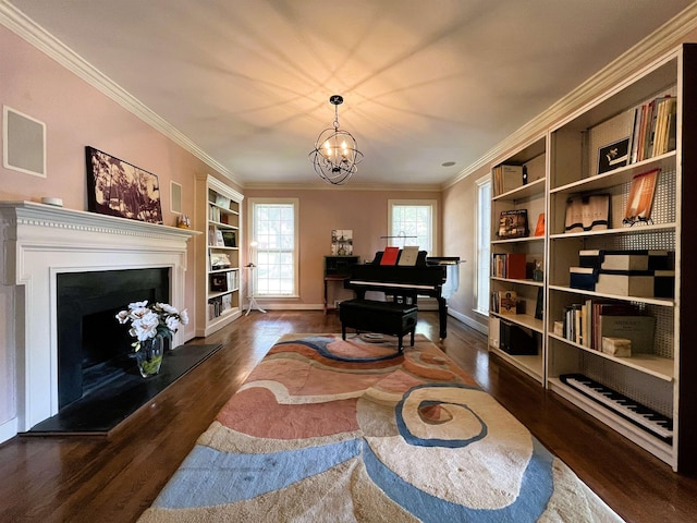 sitting room with an inviting chandelier, crown molding, a fireplace with raised hearth, and dark wood-style flooring