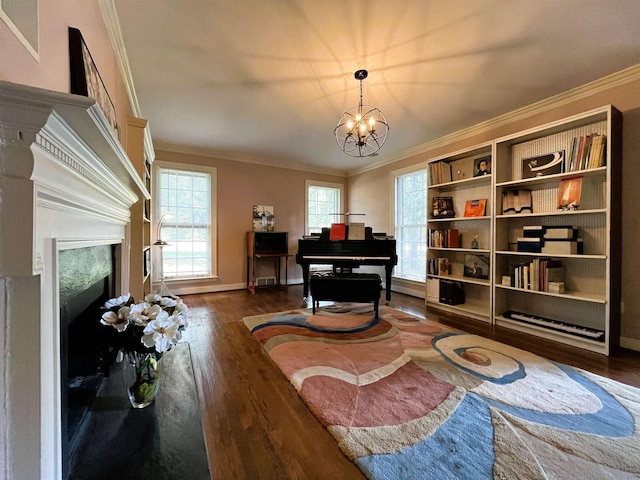 sitting room featuring a chandelier, dark wood finished floors, a high end fireplace, and crown molding