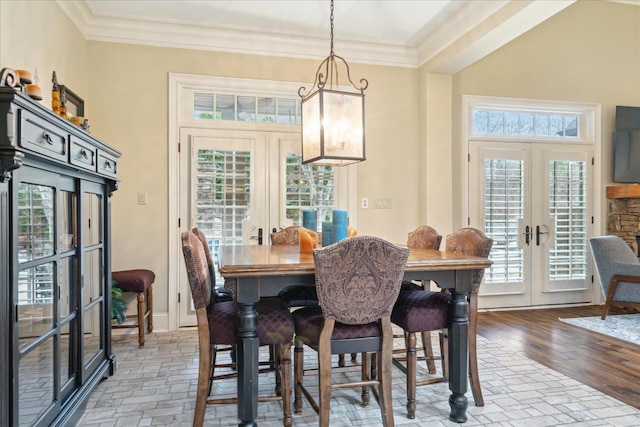 dining area featuring french doors, wood finished floors, baseboards, and ornamental molding