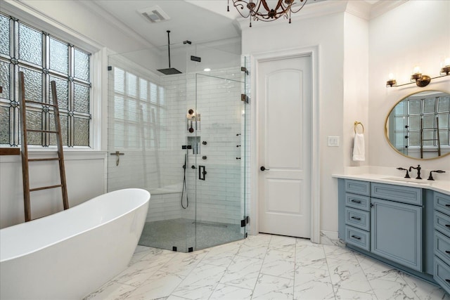 full bathroom featuring vanity, a freestanding tub, a shower stall, crown molding, and marble finish floor