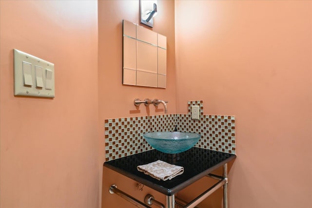 bathroom with tasteful backsplash and a sink