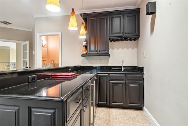 kitchen with visible vents, ornamental molding, dark stone counters, a peninsula, and baseboards