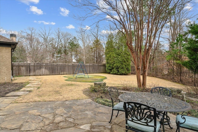 view of patio with outdoor dining area and a fenced backyard