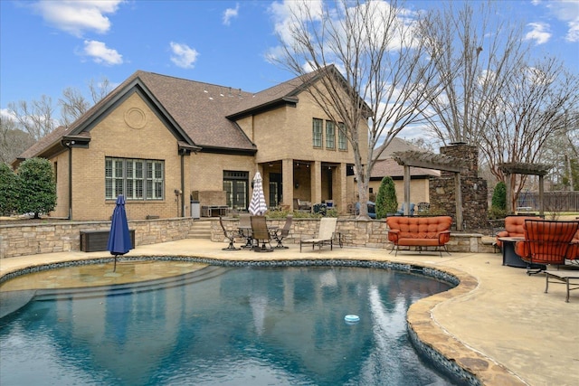 outdoor pool with a patio and a pergola