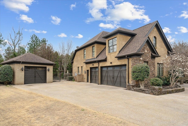 view of home's exterior featuring an outbuilding, brick siding, and a shingled roof