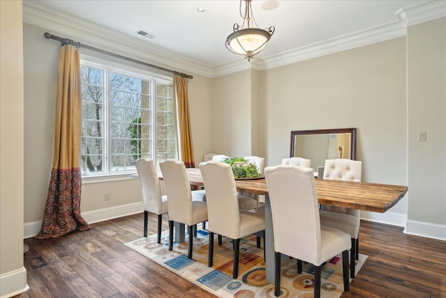 dining room with dark wood finished floors, crown molding, baseboards, and visible vents