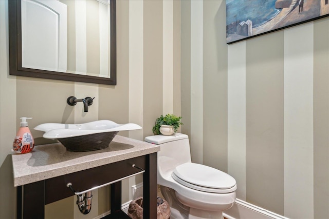 half bath featuring toilet and vanity