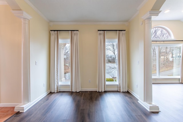 interior space with crown molding, dark wood-style floors, baseboards, and ornate columns