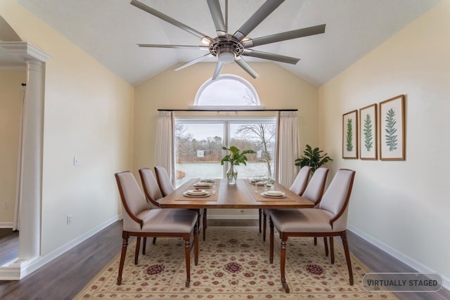 dining area with a ceiling fan, ornate columns, wood finished floors, baseboards, and vaulted ceiling