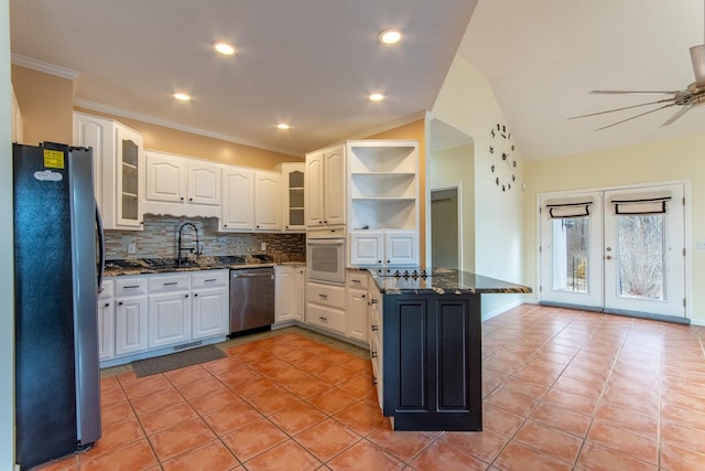 kitchen with backsplash, stainless steel appliances, french doors, dark stone counters, and white cabinets