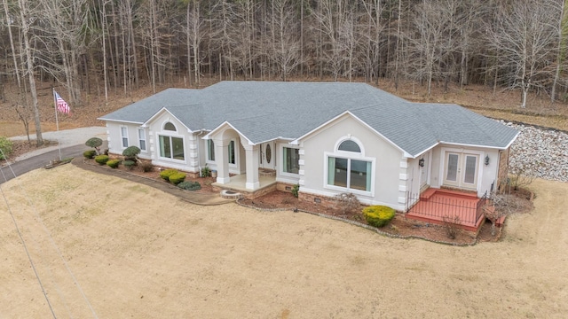 single story home featuring french doors, driveway, and a shingled roof