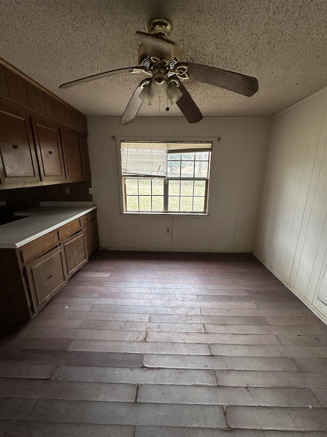 interior space with ceiling fan, light wood-style flooring, and a textured ceiling