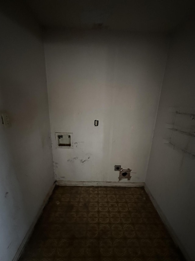 clothes washing area with tile patterned floors, hookup for an electric dryer, hookup for a washing machine, and laundry area