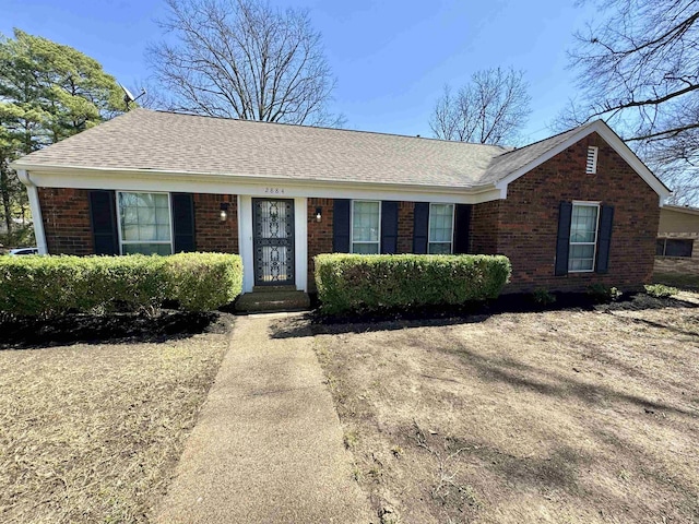 ranch-style house with brick siding and roof with shingles