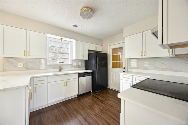 kitchen featuring dark wood-style flooring, freestanding refrigerator, a sink, white cabinets, and dishwasher